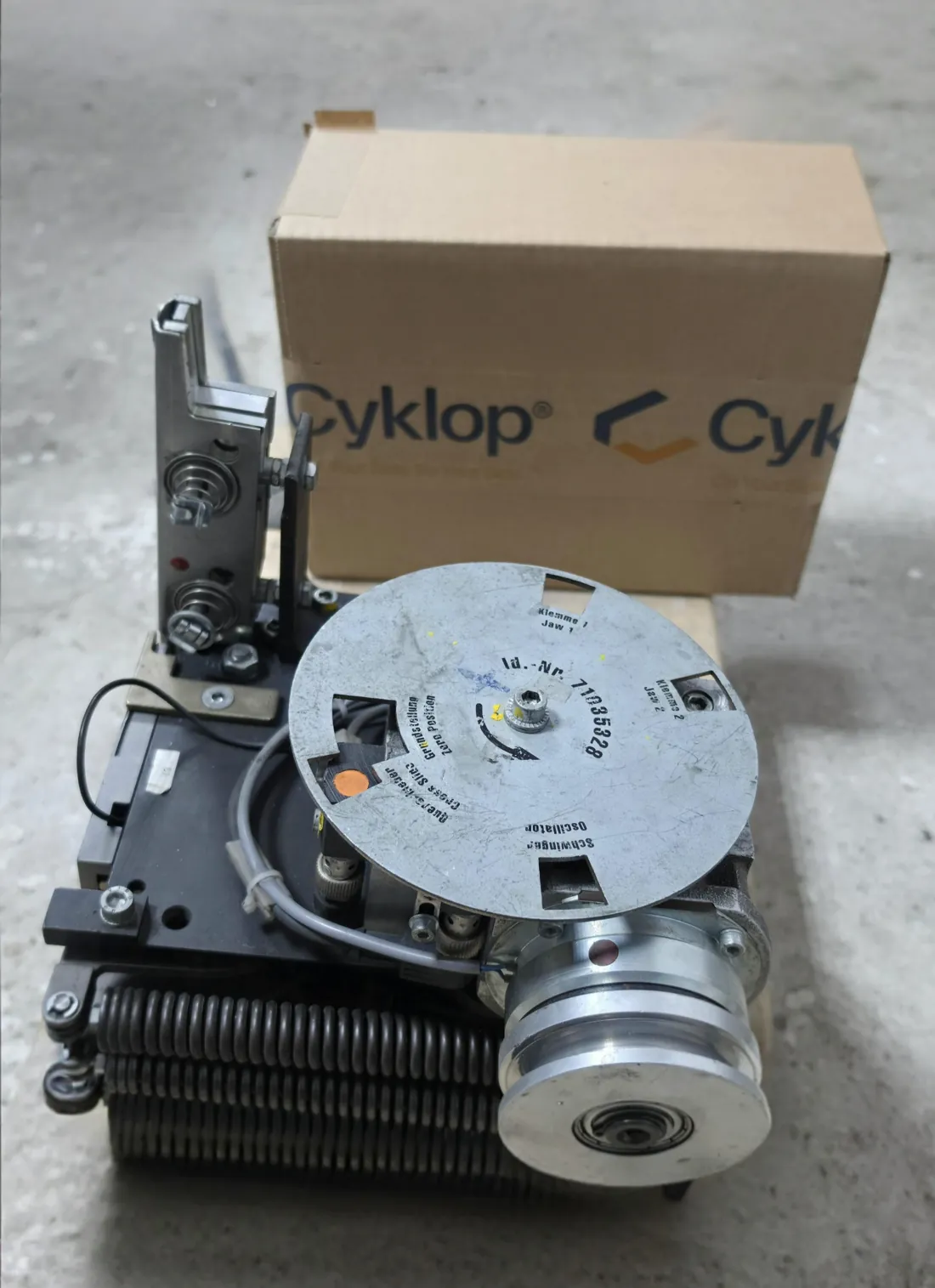 Cyklop strapping head in our workshop, jaw and oscillator disc visible