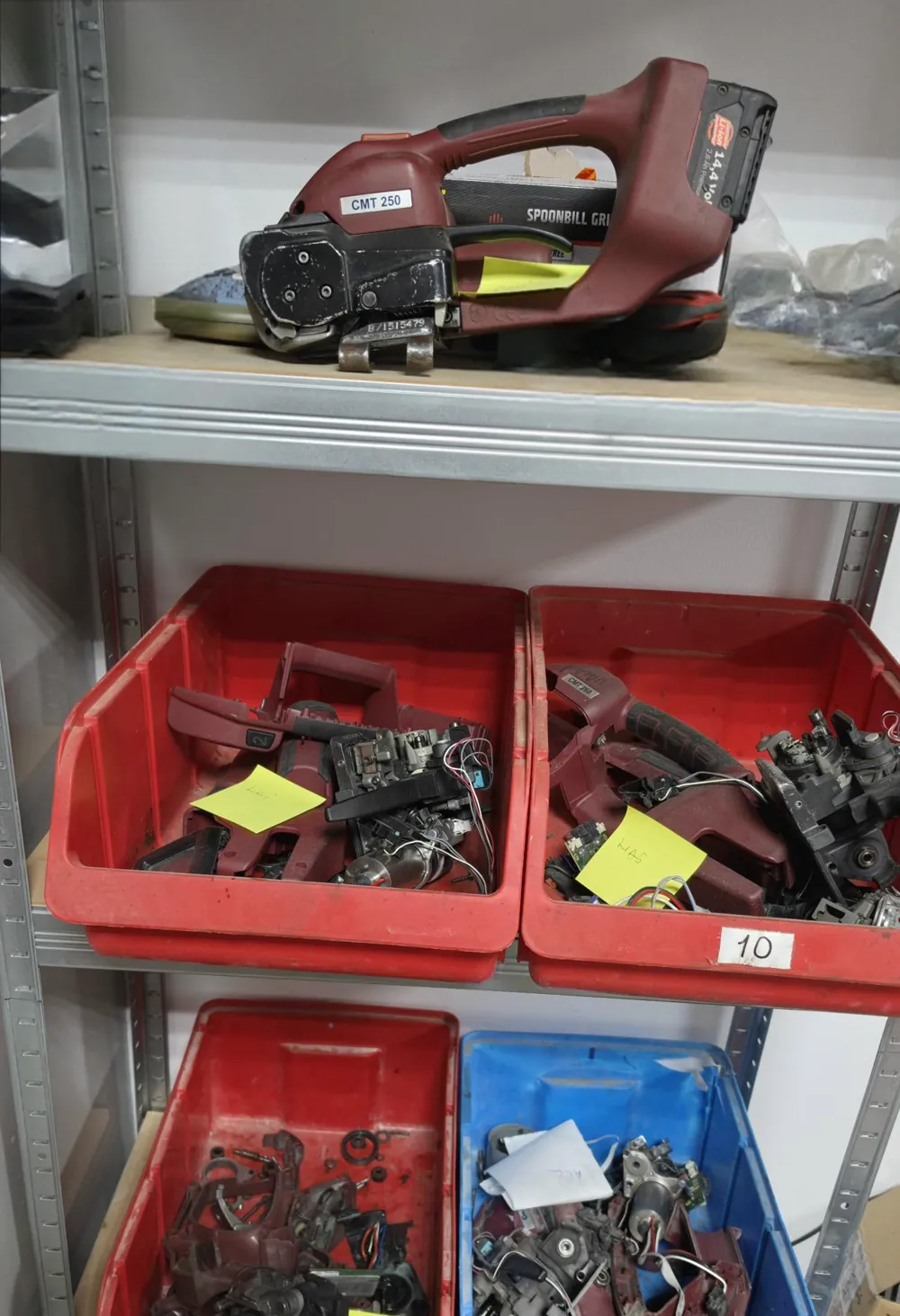 Parts stock on our workshop shelves: strapping tool housings and mechanics sorted in bins